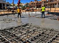 Crew placing concrete over rebar