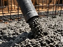 Close-up of concrete pouring from the hose