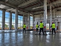 Crew finishing an interior warehouse slab