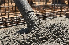Concrete pouring from a pump hose onto rebar